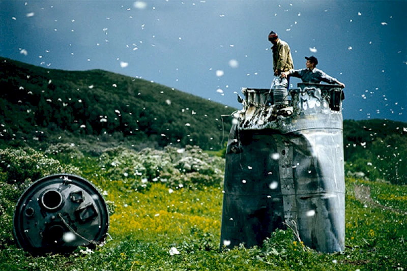 Villagers collecting scrap from a crashed spacecraft, Altai Territory, Russia, 2000 ©Jonas Bendiksen/Magnum Photos